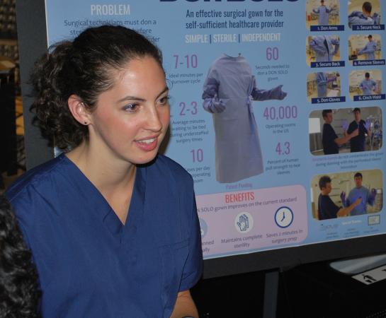 Taylor See of Don Solo tells onlookers about the surgical gown her team developed.