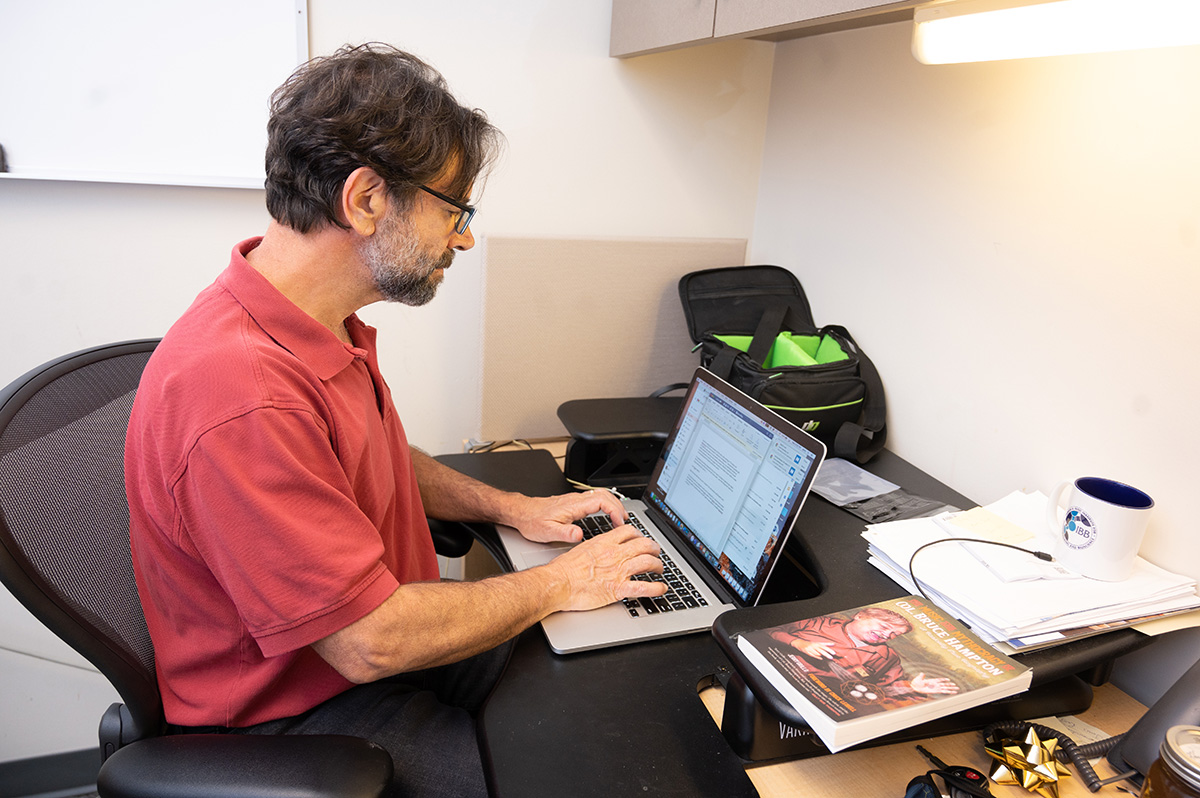 Grillo works on a story at his day job as a writer and communications professional telling the stories of researchers and students in the Coulter Department. (Photos: Allison Carter)