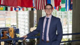 PJ Jarquin stands in what's colloquially known as the Flag Building, with flags from around the world hung from the ceiling. 