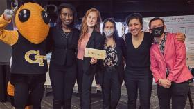 Team Baby Beatz at the Fall 2021 Capstone Design Expo with Buzz. From left, Kadidia Haidara, Carina D’Angelo, Deborah Lobaccaro, Lydia El-Sayegh, and Madeleine Tincher. (Photo Courtesy: Team Baby Beatz)