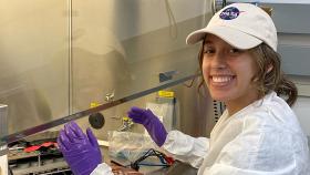 Fourth-year biomedical engineering student and Space Tango intern Nicole Frey at a lab hood with the CubeLab scheduled to fly to the International Space Station July 14 aboard a SpaceX Dragon capsule. (Photo Courtsey: Nicole Frey and Space Tango)
