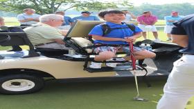 Bobby Baird is setting up his first golf shot using the new Georgia Tech designed seat on an E-Z-GO golf car before the Bobby Jones Classic!