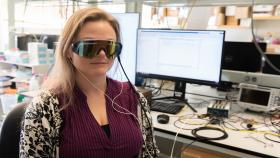 Annabelle Singer models an experimental visor and earphones that play 40 Hertz light and sound.