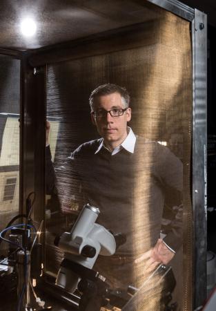 School of Mechanical Engineering associate professor Craig Forest has developed automated patch-­clamping instruments to accelerate the recording of information from neurons. In this photo, an instrument is protected by a Faraday cage. Credit: Georgia Tech / Rob Felt