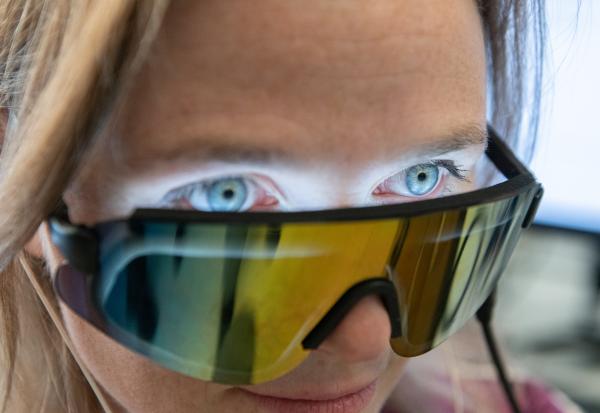 Researcher Annabelle Singer models an experimental visor and earphones that play 40 Hertz light and sound. The current study was performed on mice. The pictured device is in human testing as a possible Alzheimer's treatment. Results from those tests are to be published in later studies separate from the current study in mice. Credit: Georgia Tech / Allison Carter