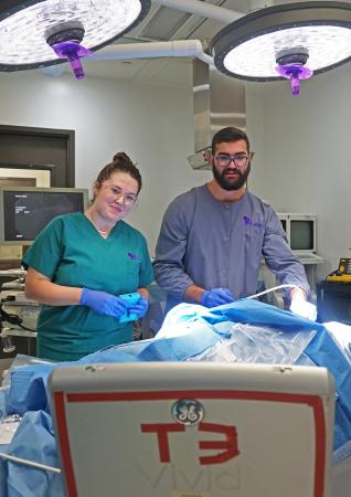 BME students Annika Clawson and Robert Bridenhagen test their prototype at T3 Labs.