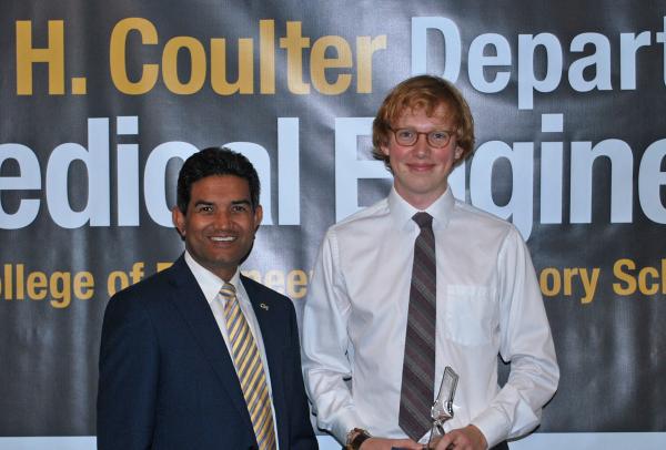 Benjamin Ashby is congratulated by Karun Jain after winning the Dr. G.D. Jain - Outstanding Senior Award.