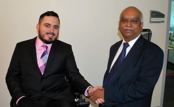 Sathya Gourisankar (right), director of the MBID program, congratulates its 100th graduate, Ignacio Montoya.