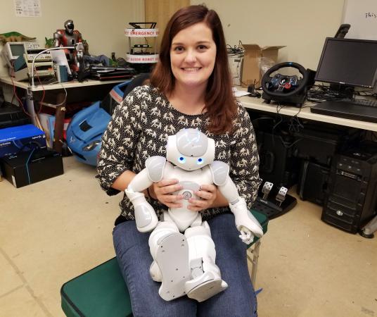 Katelyn Fry poses with NAO.