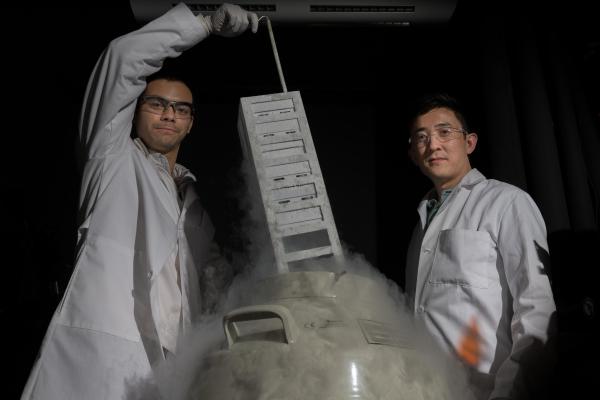 Assistant professor Gabe Kwong (r.) and graduate research assistant Ian Miller (l.) in Kwong's lab at Georgia Tech. T-cells are preserved in the lab in liquid nitrogen. Credit: Georgia Tech / Allison Carter