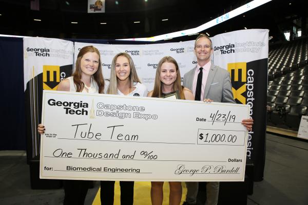 Tube Team takes center stage to accept their BME Capstone award. Left to right are Emily Dunford, Arielle Margulies, Sarah Nixon, and Director of BME Capstone, James Rains.