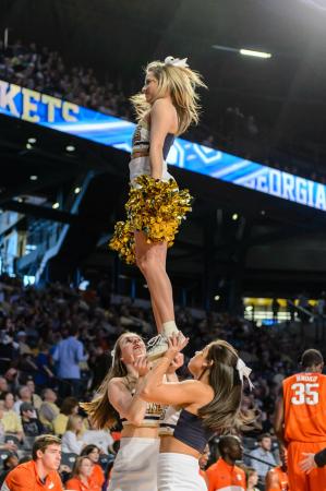 María Díaz Ortiz, a biomedical engineering major, supports a teammate during a stunt at a basketball game. 