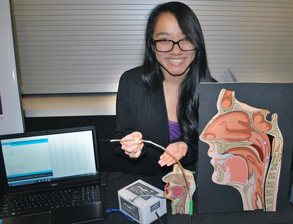 Stephanie Zhang of Sweet DreamzZZ demonsrates the diagnostic tool her team developed for sleep apnea.
