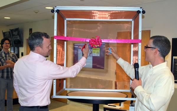 Garrett Stanley (left) and Craig Forest cut the ceremonial ribbon at the grand opening for the Neuro Design Suite.