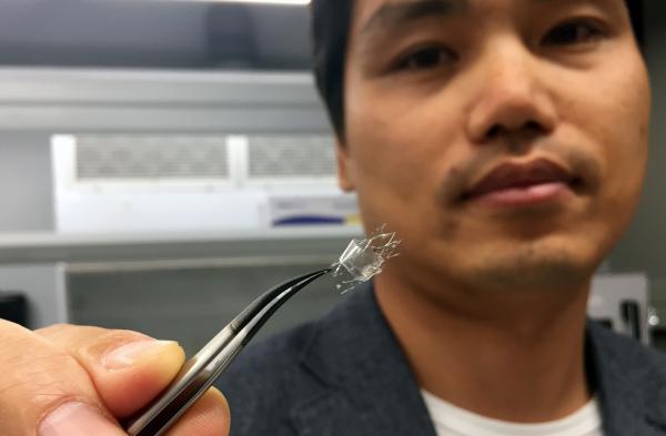 Woon-Hong Yeo, an assistant professor in Georgia Tech’s George W. Woodruff School of Mechanical Engineering and Wallace H. Coulter Department of Biomedical Engineering, holds a flow sensor on a stent backbone. (Credit: John Toon, Georgia Tech)