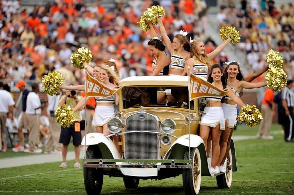 María Díaz Ortiz (front right), a biomedical engineering major, rides on the Ramblin' Wreck during a football game. 