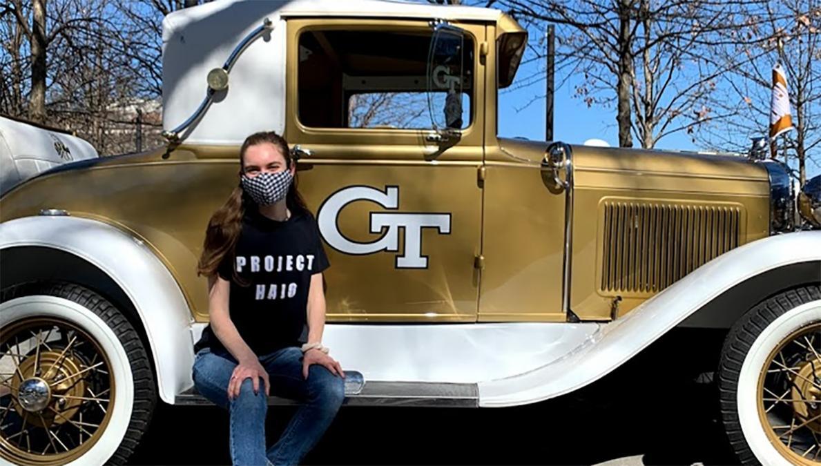 Brady Bove sits on the running board of the Ramblin Wreck.