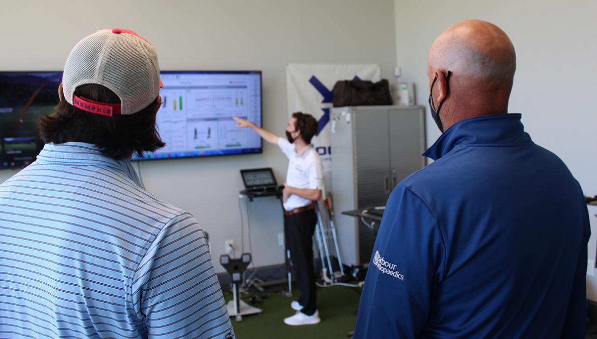 Second-year mechanical engineering student Brittan Pero talks through some of the data collected during tests of a 3D-printed putter with Tech alumni Reagan Cink, left, and his father, Stewart, a PGA Tour pro golfer. Pero joined the project this summer to help with testing and build on the design created by biomedical engineering student Caroline Means. (Photo: Joshua Stewart)