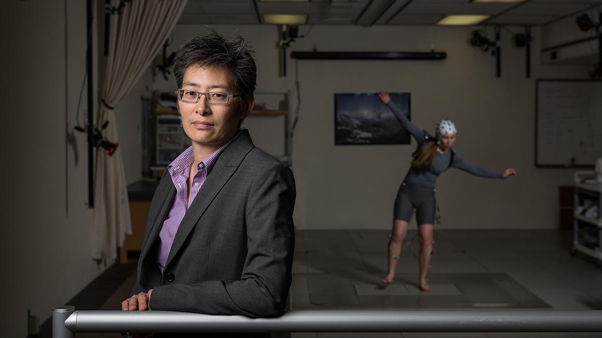 Lena Ting in her lab with a subject in the background. (Photo: Rob Felt)