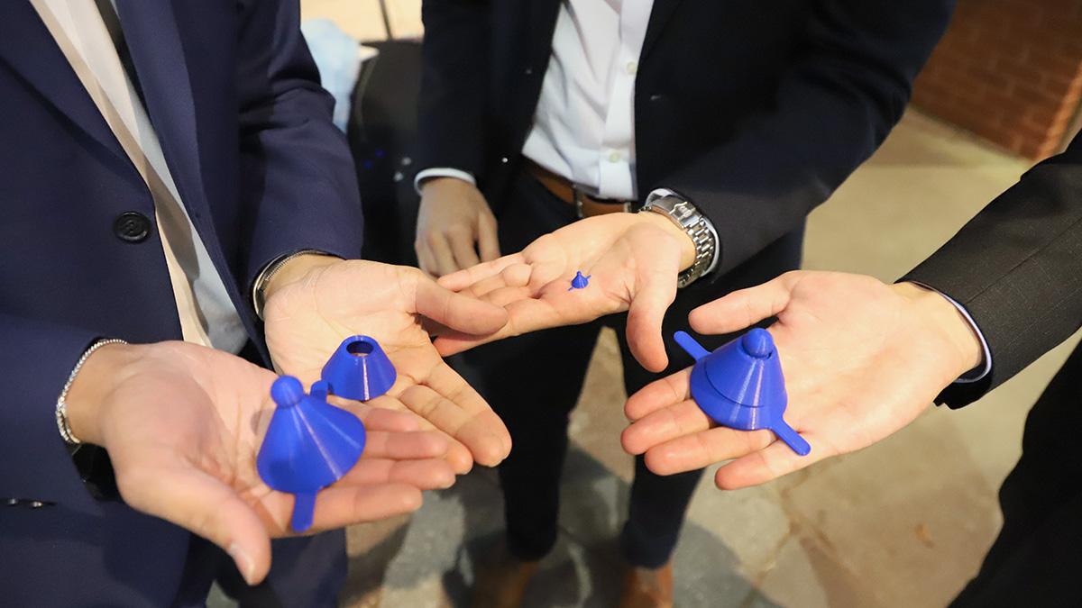 Closeup of hands holding scaled-up versions of their device for closing the carotid artery after a catheterization following a stroke. (Photo: Joshua Stewart)