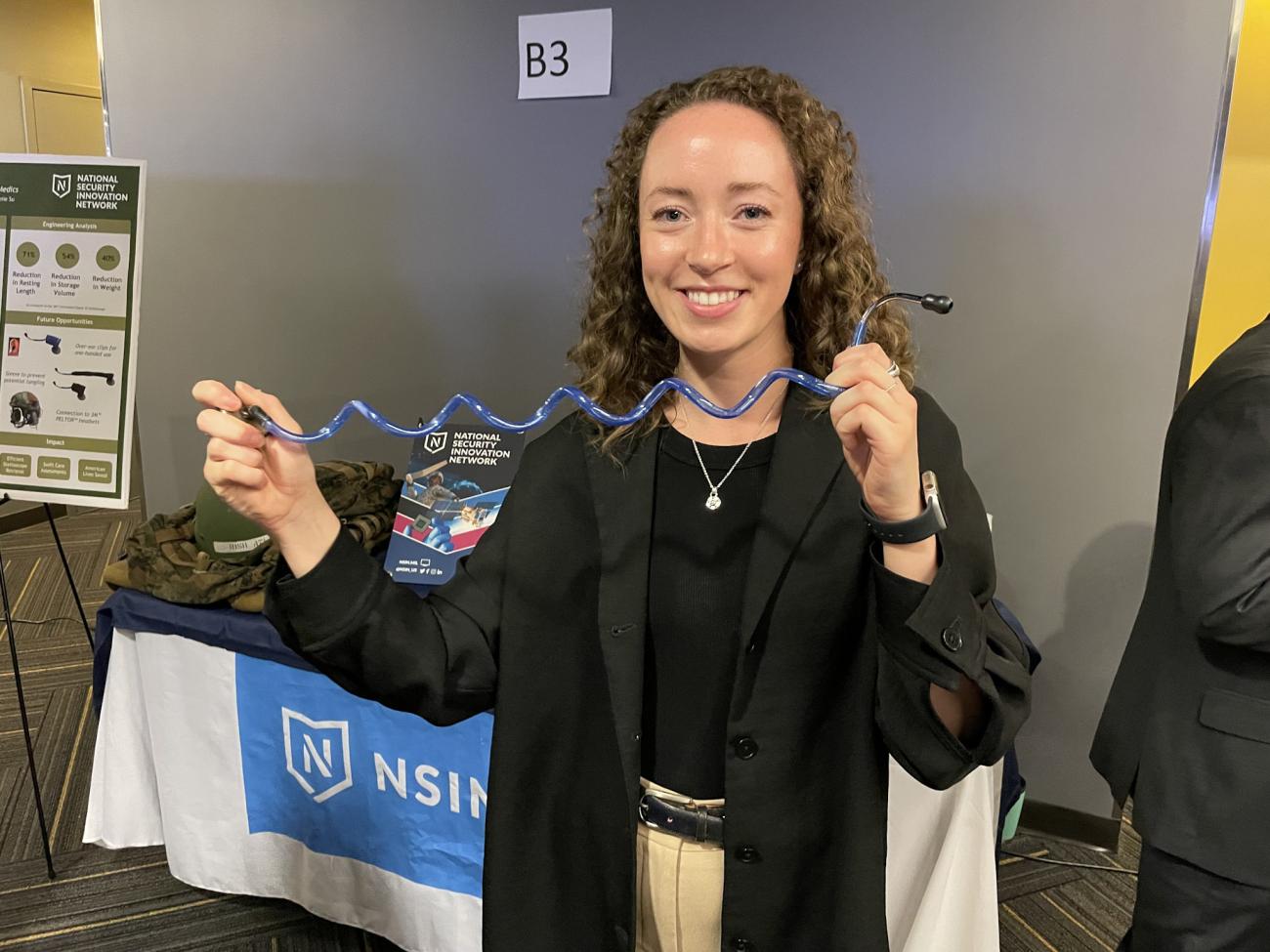 Senior BME student holding a device her group designed for Georgia Tech's Capstone Expo in April 2023